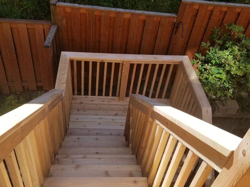 Cedar deck stairs added as part of home addition by ArchAngel Construction Services