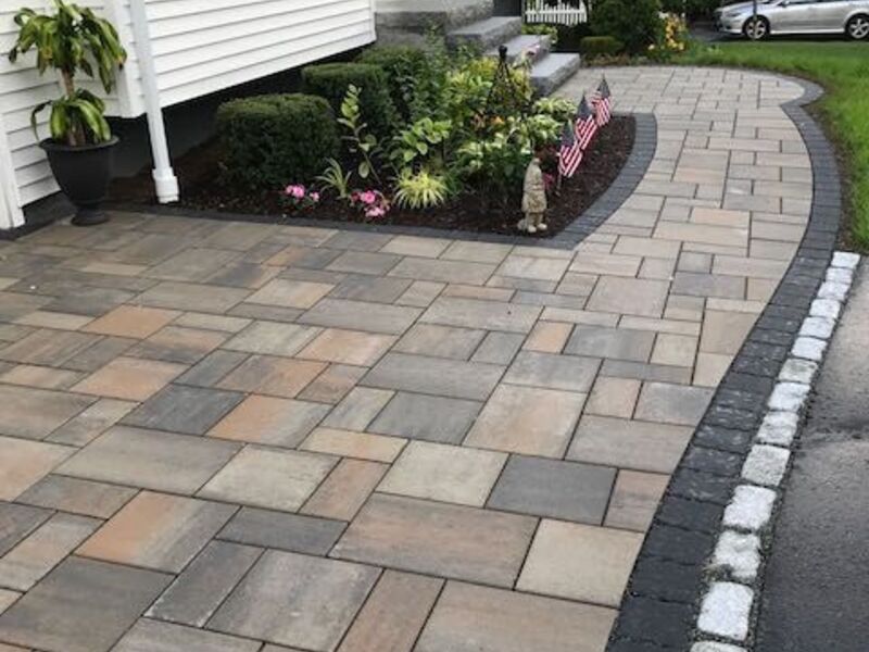 Paver driveway and walkway with granite cobblestone border