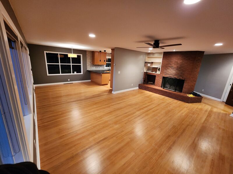 Finished hardwood flooring, open living and kitchen area