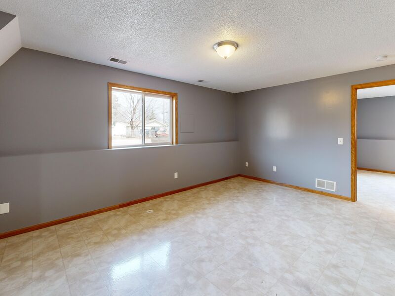 Freshly painted sunroom with fireplace and vaulted ceiling