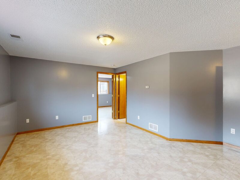 Freshly painted two-story entryway with staircase